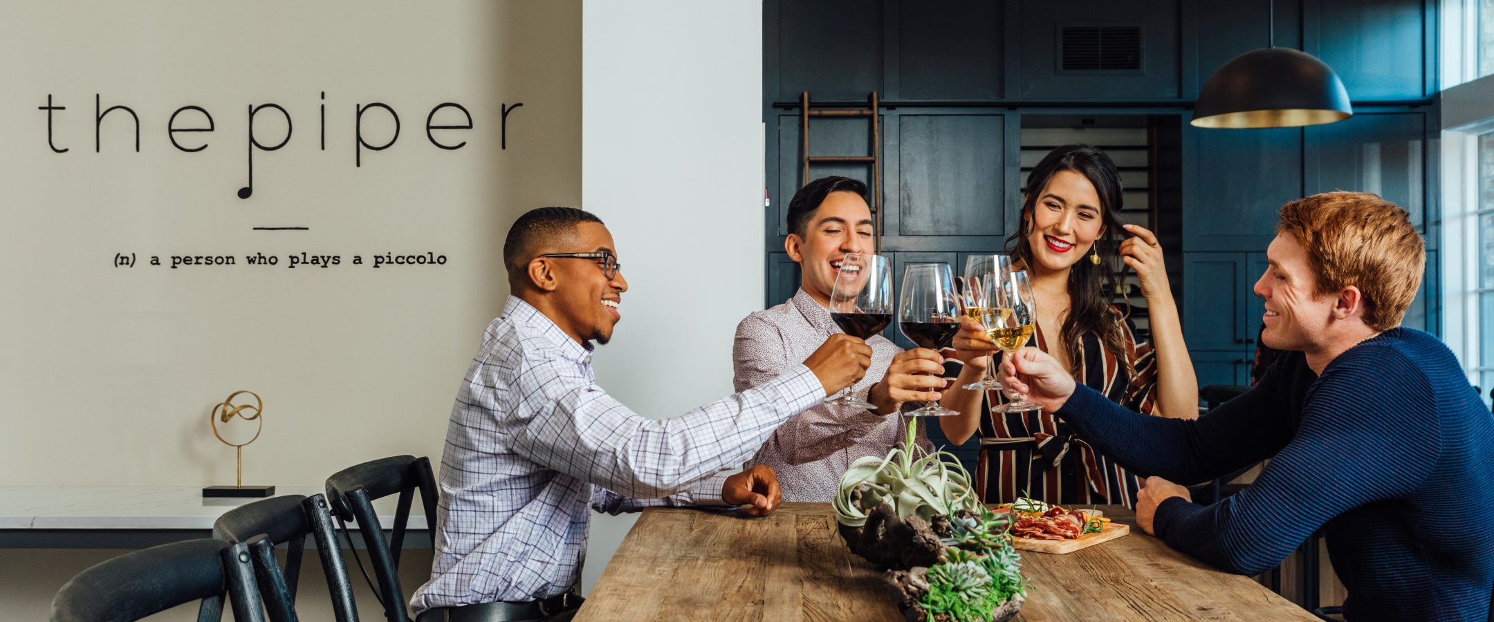 Friends at a high table drinking wine.